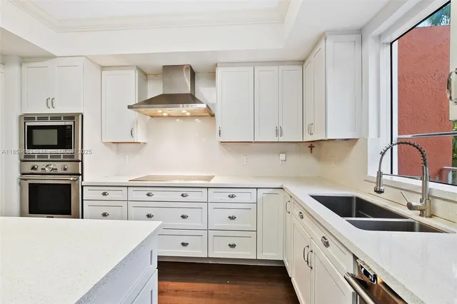 a kitchen with a sink a stove a refrigerator and cabinets