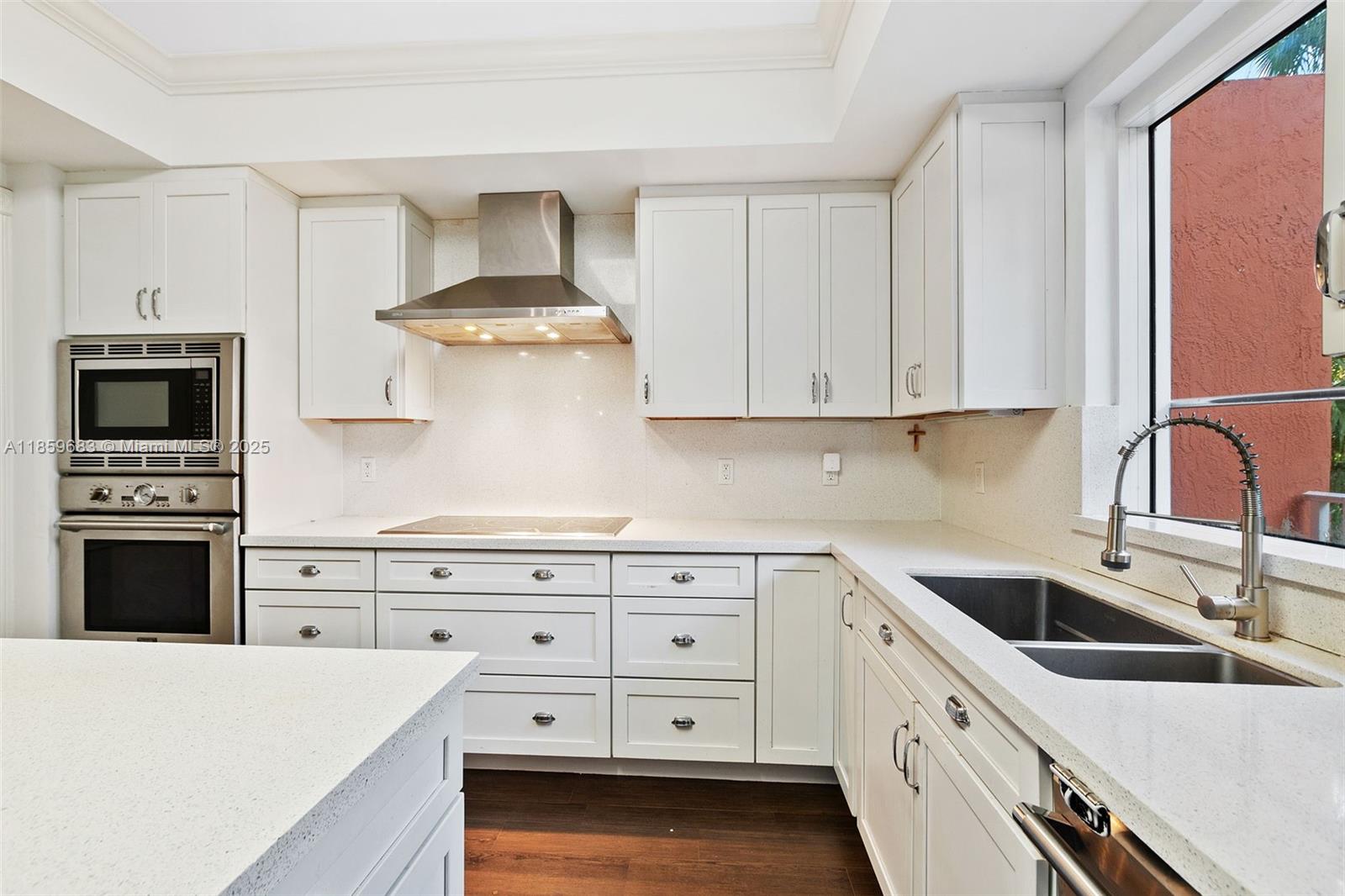 781 Crandon Boulevard, Unit 306 Key Biscayne, FL 33149 - Photo 24 of 32 a kitchen with granite countertop a stove sink and refrigerator