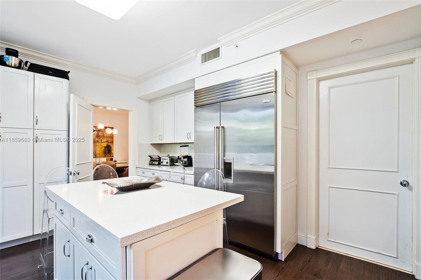 781 Crandon Boulevard, Unit 306 Key Biscayne, FL 33149 - Photo 25 of 32 a kitchen with a sink a stove a refrigerator and cabinets