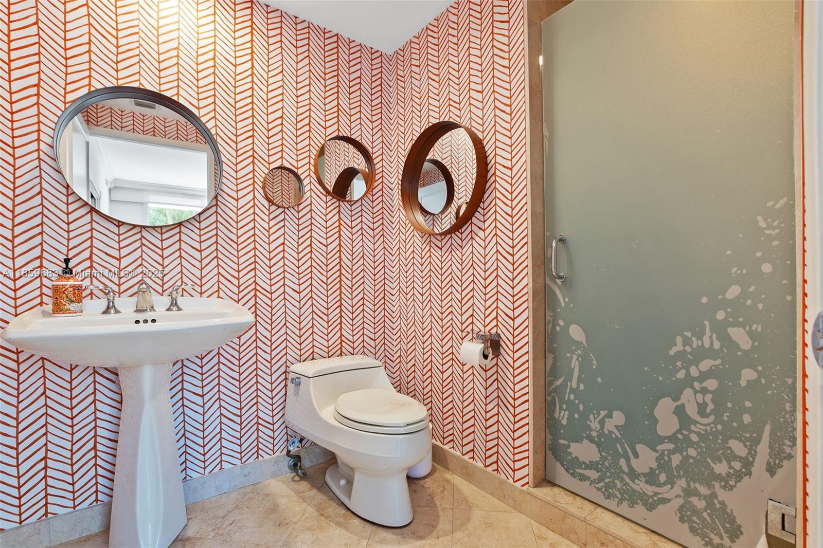 781 Crandon Boulevard, Unit 306 Key Biscayne, FL 33149 - Photo 27 of 32 a bathroom with a toilet sink and mirror