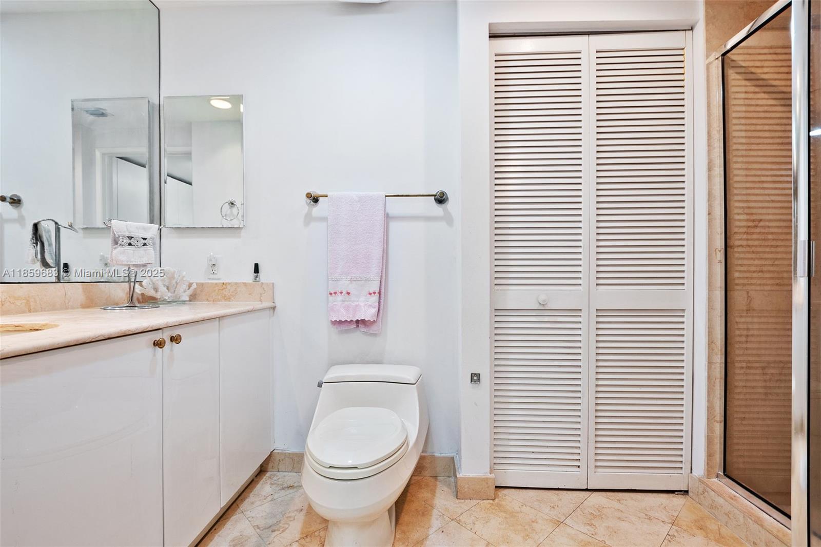 781 Crandon Boulevard, Unit 306 Key Biscayne, FL 33149 - Photo 29 of 32 a bathroom with a toilet a sink and a window