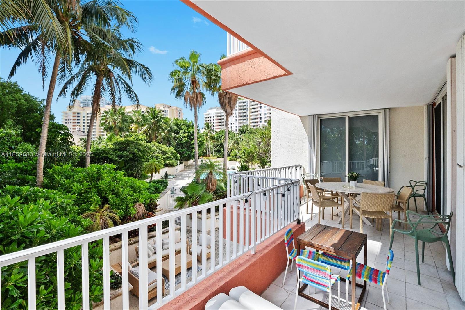 781 Crandon Boulevard, Unit 306 Key Biscayne, FL 33149 - Photo 32 of 32 a view of a chair and tables in the balcony