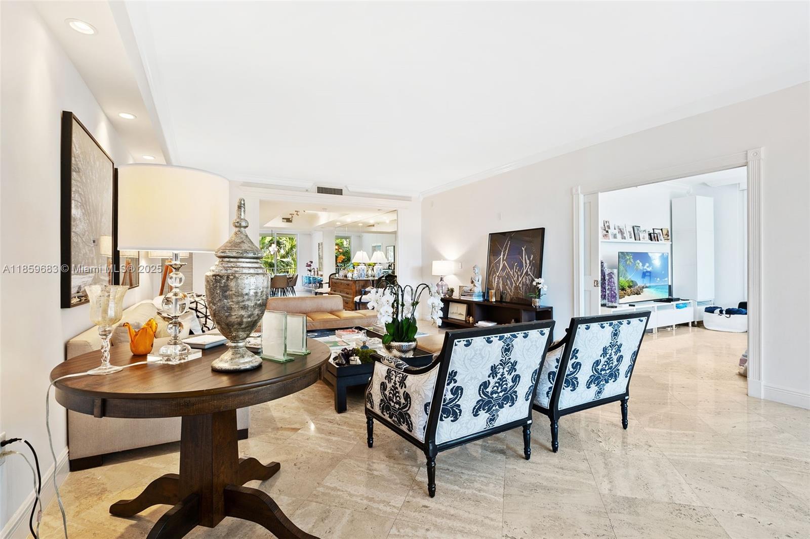 781 Crandon Boulevard, Unit 306 Key Biscayne, FL 33149 - Photo 10 of 32 a living room with furniture and a table