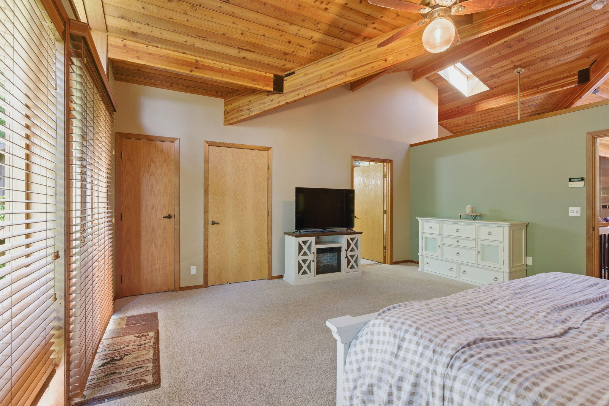 856 Greentree Loop Grants Pass, OR 97527 - Photo 25 of 62 a bedroom with a bed and a flat tv screen on wall