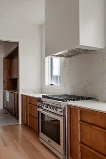 a kitchen with stainless steel appliances granite countertop a sink stove and cabinets