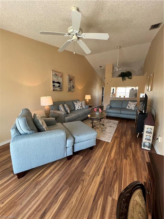 185 Grand Oaks Way, Unit R204 Naples, FL 34110 - Photo 10 of 18 a living room with furniture and a chandelier