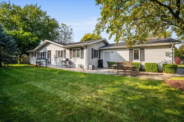 a front view of house with yard and green space