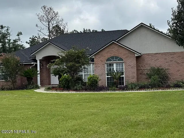 a front view of a house with a yard