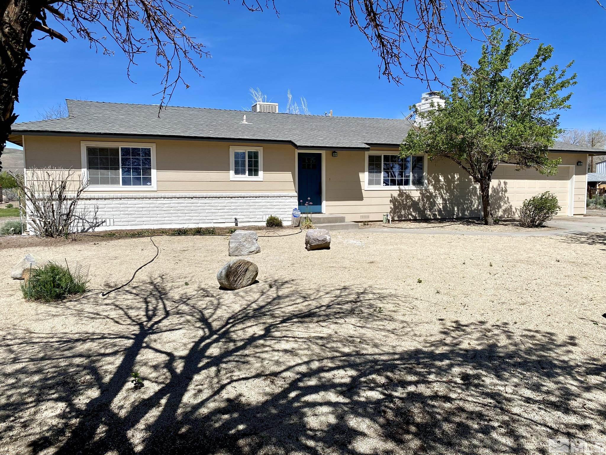 10775 Osage Road Reno, NV 89508 - Photo 1 of 22 a front view of a house with a yard