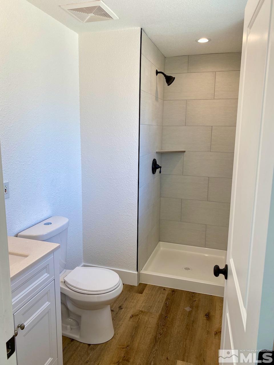 10775 Osage Road Reno, NV 89508 - Photo 15 of 22 a bathroom with a toilet and a shower