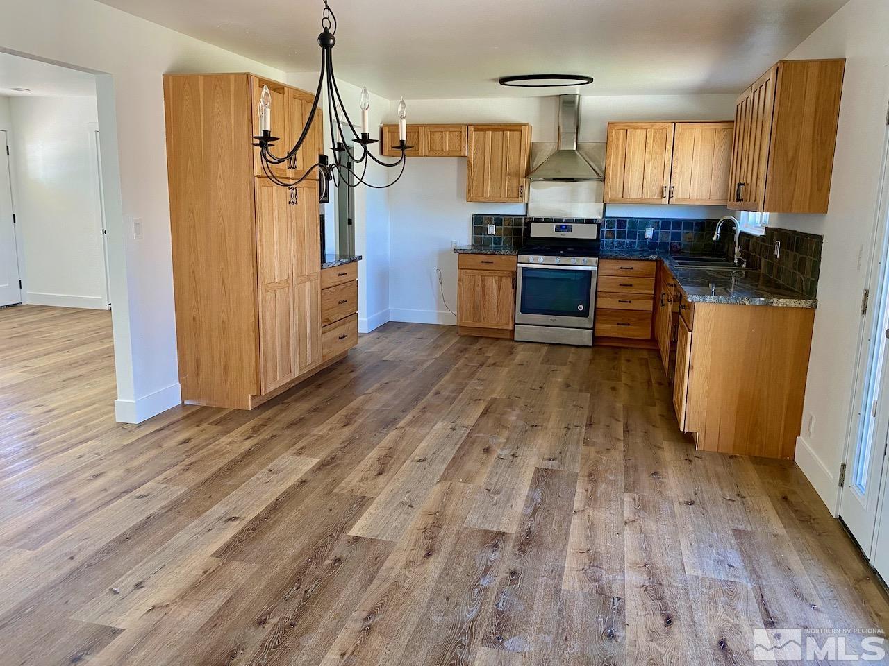 10775 Osage Road Reno, NV 89508 - Photo 2 of 22 a view of a kitchen with wooden floor and cabinets
