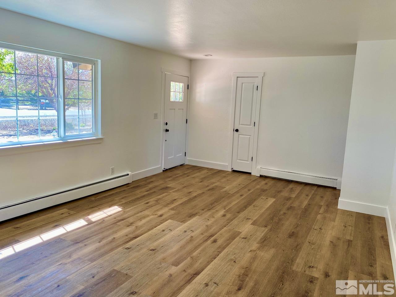10775 Osage Road Reno, NV 89508 - Photo 5 of 22 an empty room with wooden floor and windows