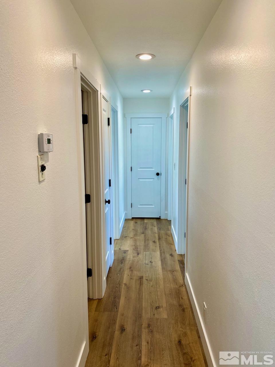 10775 Osage Road Reno, NV 89508 - Photo 8 of 22 a view of a hallway with wooden floor