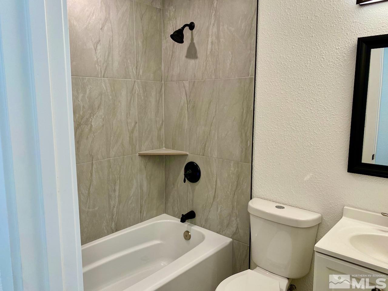 10775 Osage Road Reno, NV 89508 - Photo 9 of 22 a bathroom with a toilet and shower