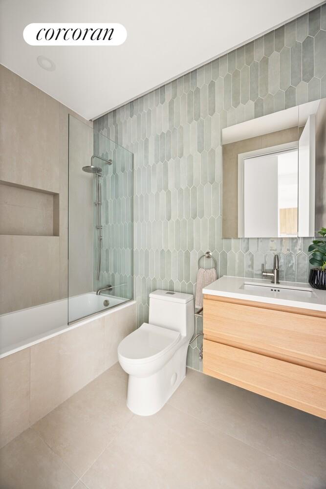 48 Stanhope Street, Unit 3R Brooklyn, NY 11221 - Photo 7 of 9 a bathroom with a sink a toilet and a bathtub