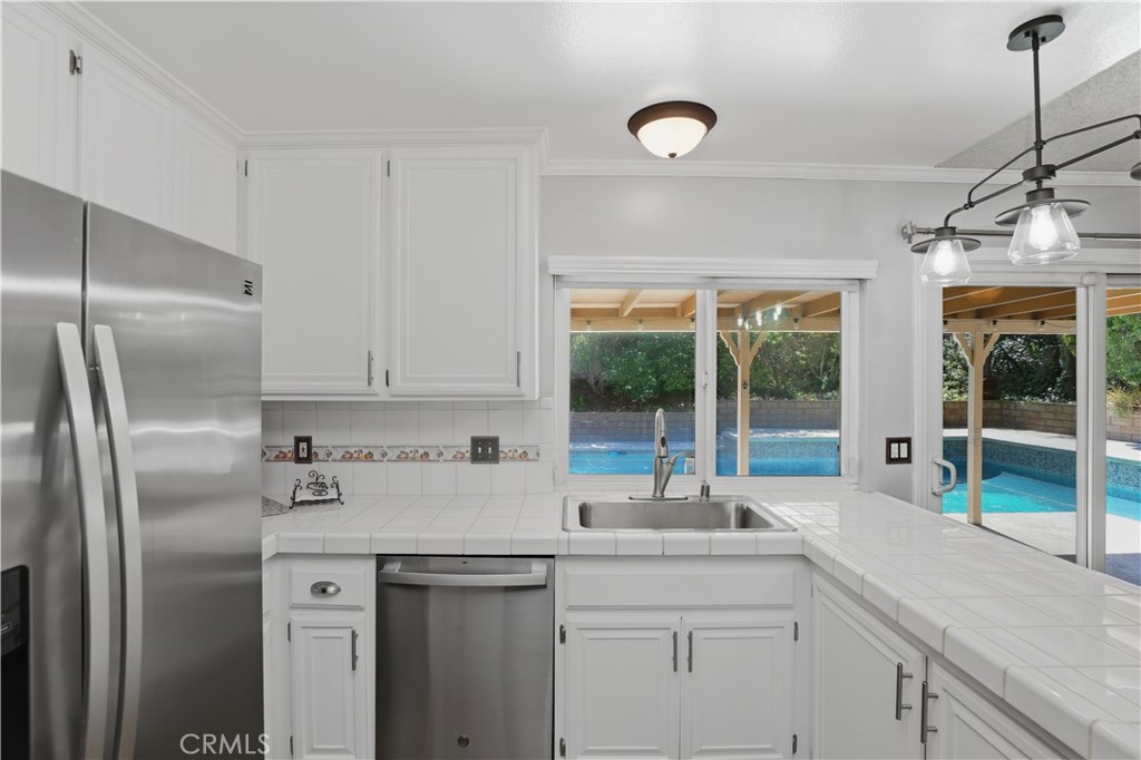 1340 Cadwell Court Riverside, CA 92506 - Photo 20 of 63 a kitchen with stainless steel appliances granite countertop a sink and a refrigerator