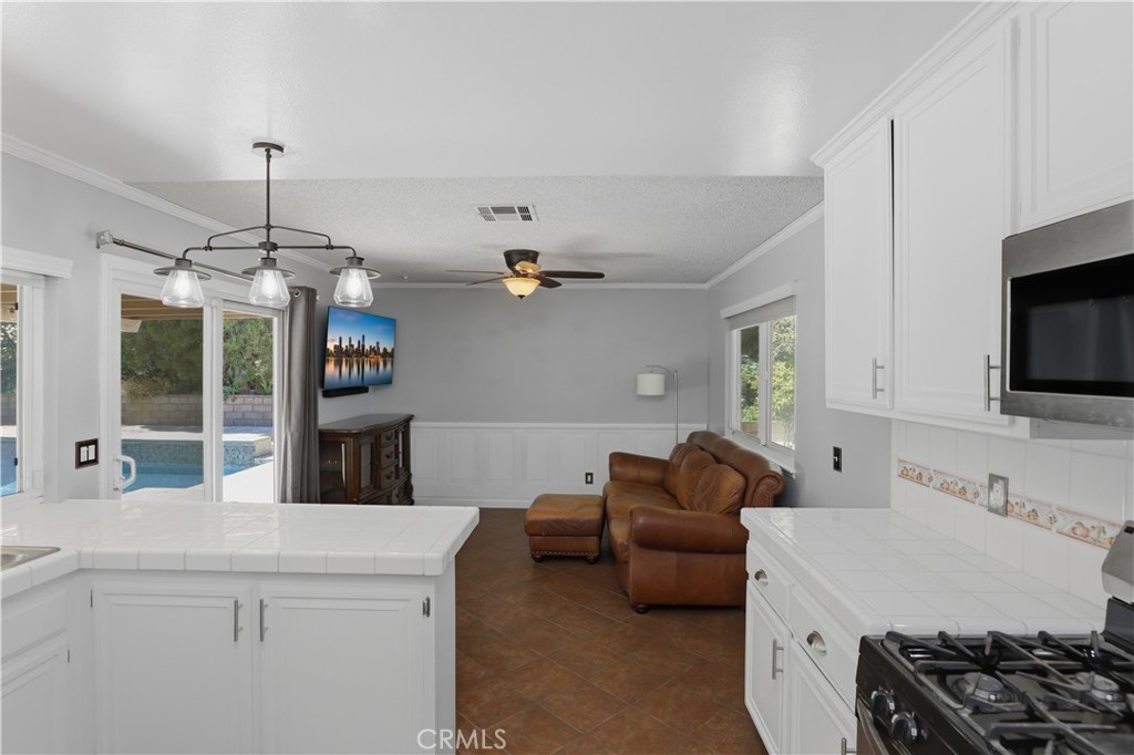 1340 Cadwell Court Riverside, CA 92506 - Photo 21 of 63 a living room with furniture and a flat screen tv