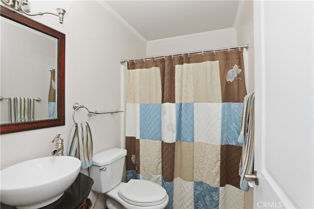 1340 Cadwell Court Riverside, CA 92506 - Photo 25 of 63 a white toilet sitting next to a bathroom sink