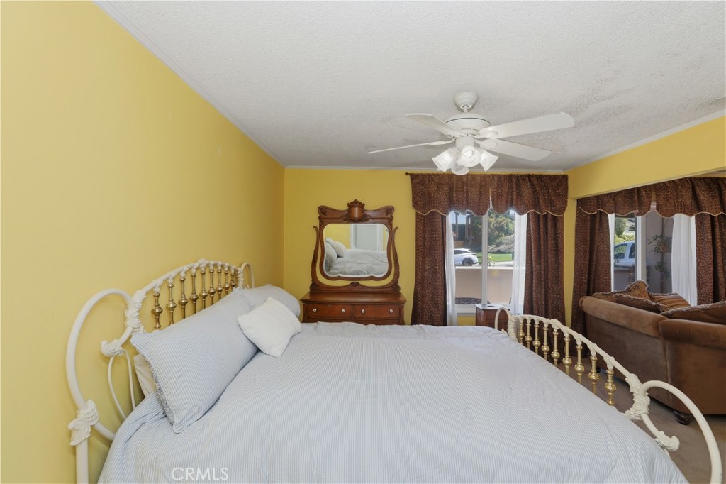 1340 Cadwell Court Riverside, CA 92506 - Photo 27 of 63 a bedroom with a bed and dresser with wooden floor