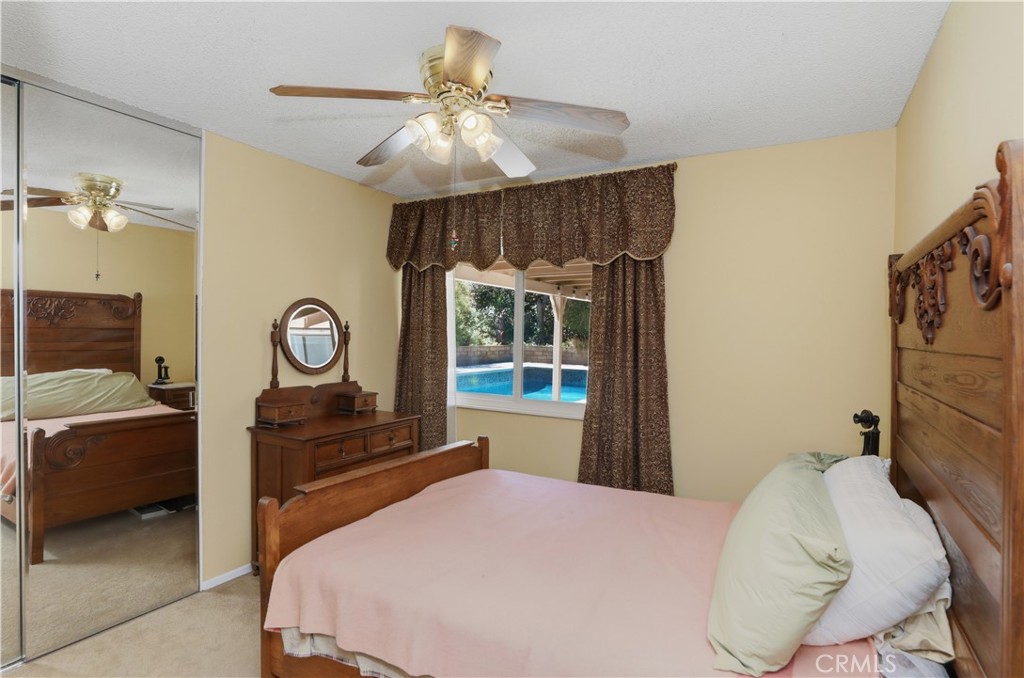1340 Cadwell Court Riverside, CA 92506 - Photo 31 of 63 a bedroom with a bed and a chandelier