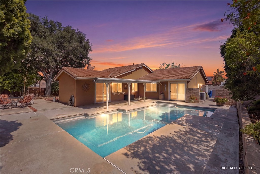 1340 Cadwell Court Riverside, CA 92506 - Photo 36 of 63 a view of a house with swimming pool next to a yard