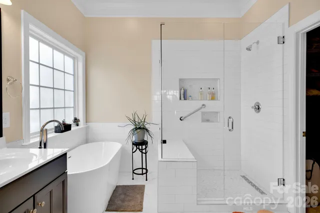 a bathroom with a tub sink and mirror