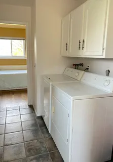 a utility room with a sink washer and dryer