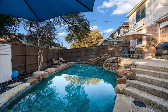 a view of a swimming pool with a patio