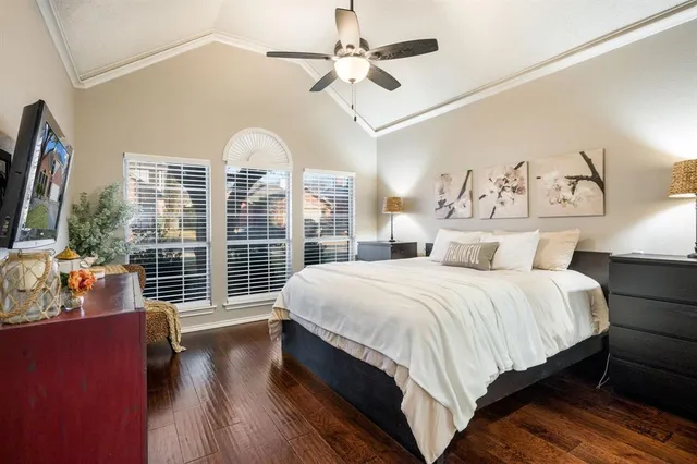 a spacious bedroom with a bed and a large window