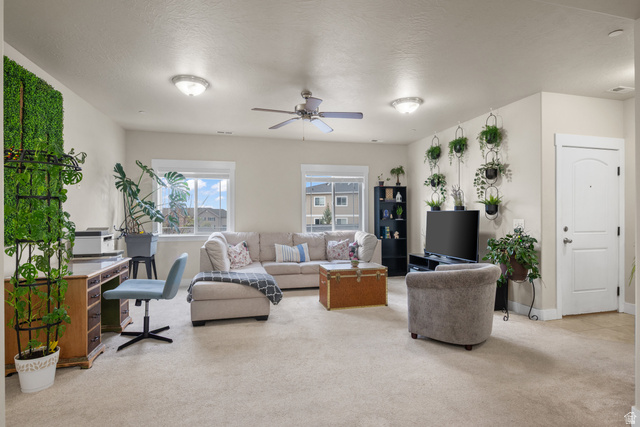 1977 North Crest Road, Unit 1977 Saratoga Springs, UT 84045 - Photo 1 of 1 Living area featuring light carpet, a ceiling fan, an office area, and a textured ceiling