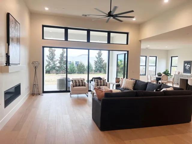 a living room with furniture and a floor to ceiling window