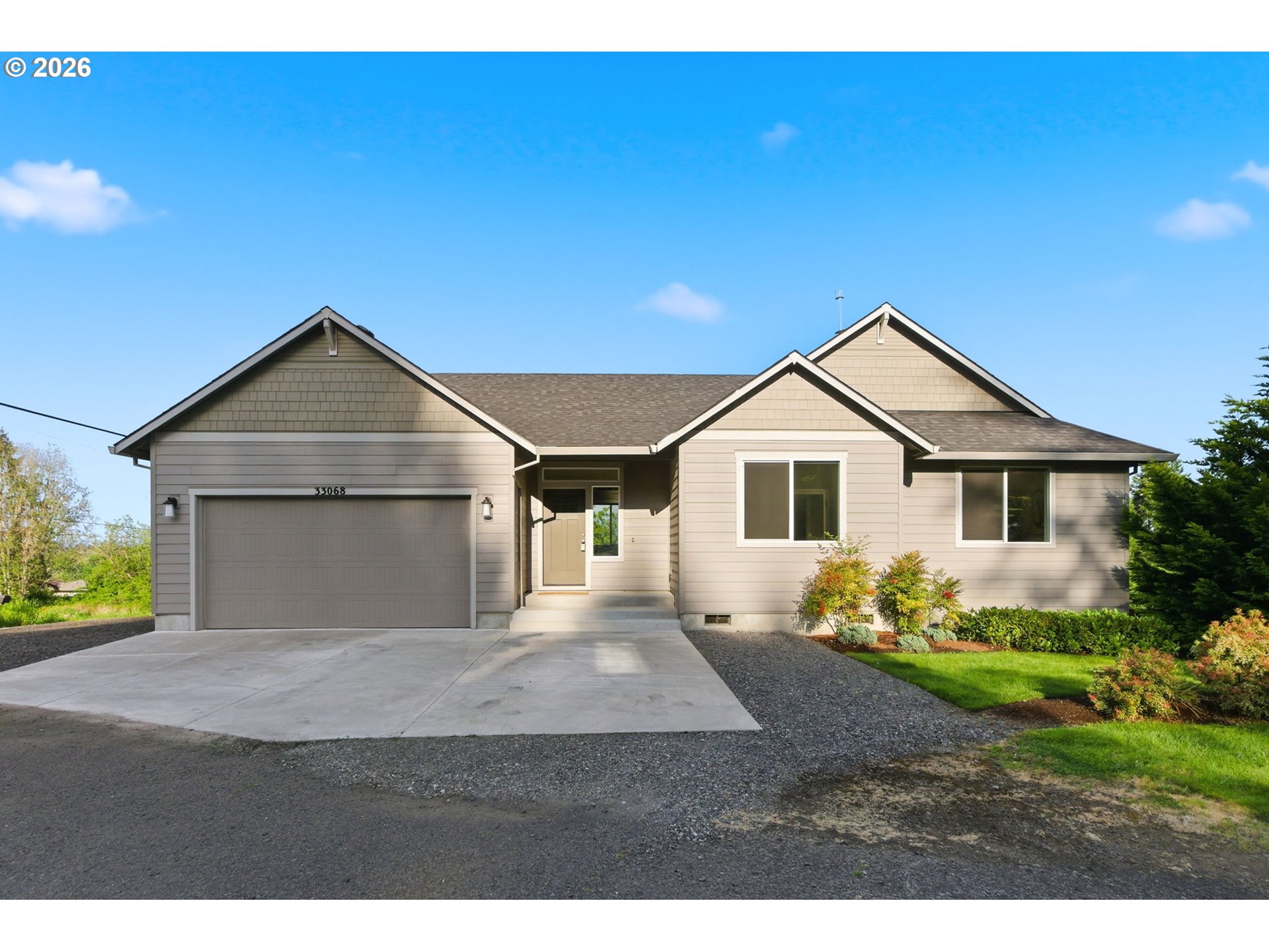 33068 Northwest Ej Smith Road Scappoose, OR 97056 - Photo 3 of 43 a front view of a house with a yard and garage