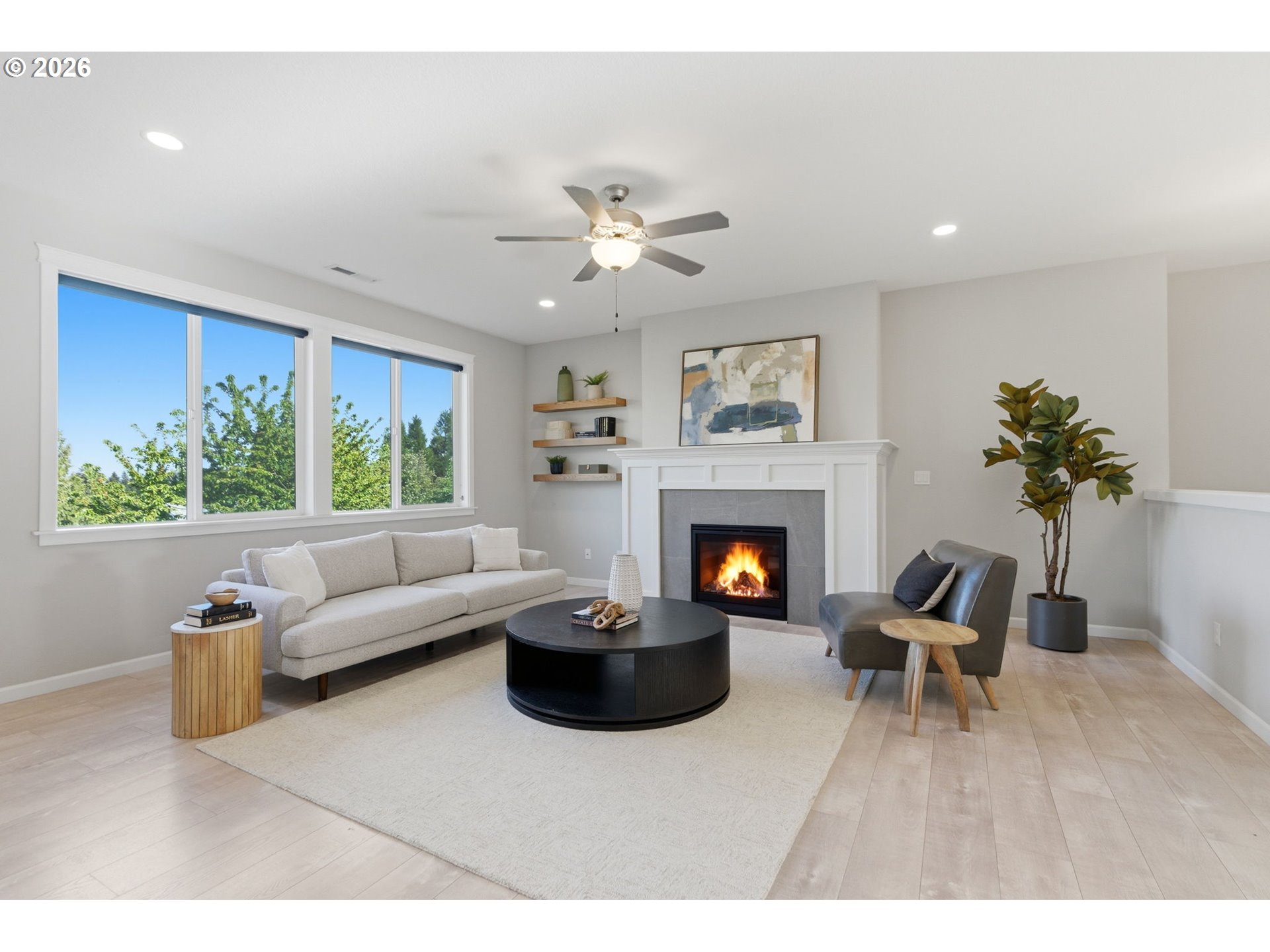 33068 Northwest Ej Smith Road Scappoose, OR 97056 - Photo 10 of 43 a living room with furniture a fireplace and a large window