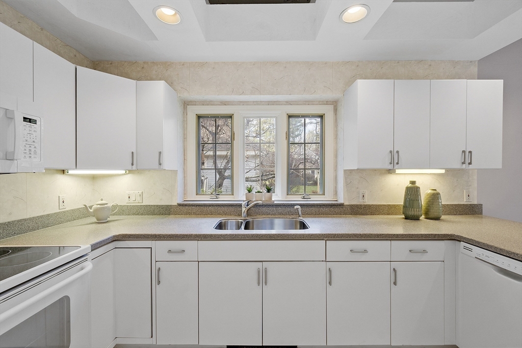 34 Pickman Drive Bedford, MA 01730 - Photo 20 of 38 a kitchen with sink cabinets and window