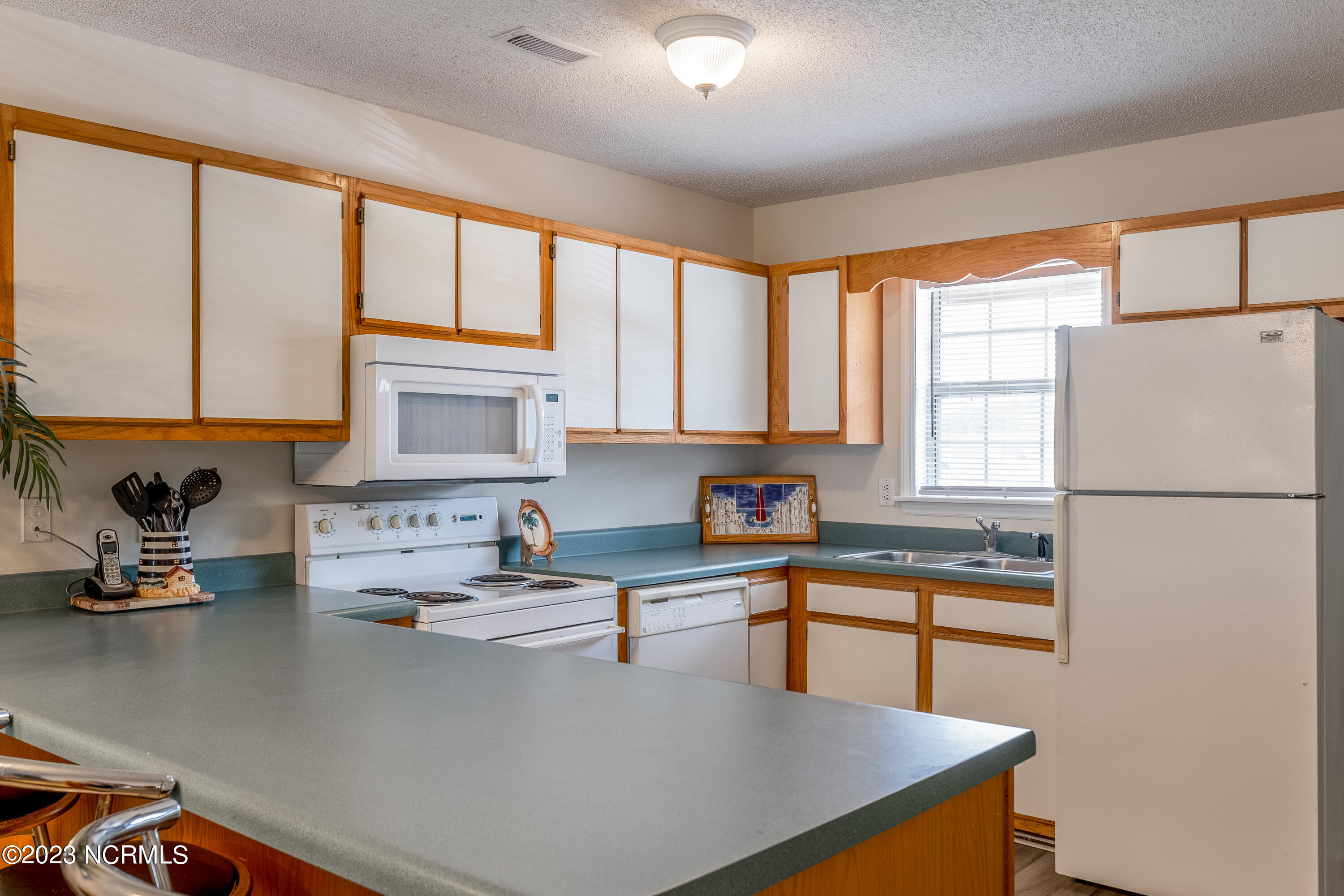 601 Peletier Loop Road, Unit E27 Swansboro, NC 28584 - Photo 4 of 17 View of Kitchen from Dining Combo Space
