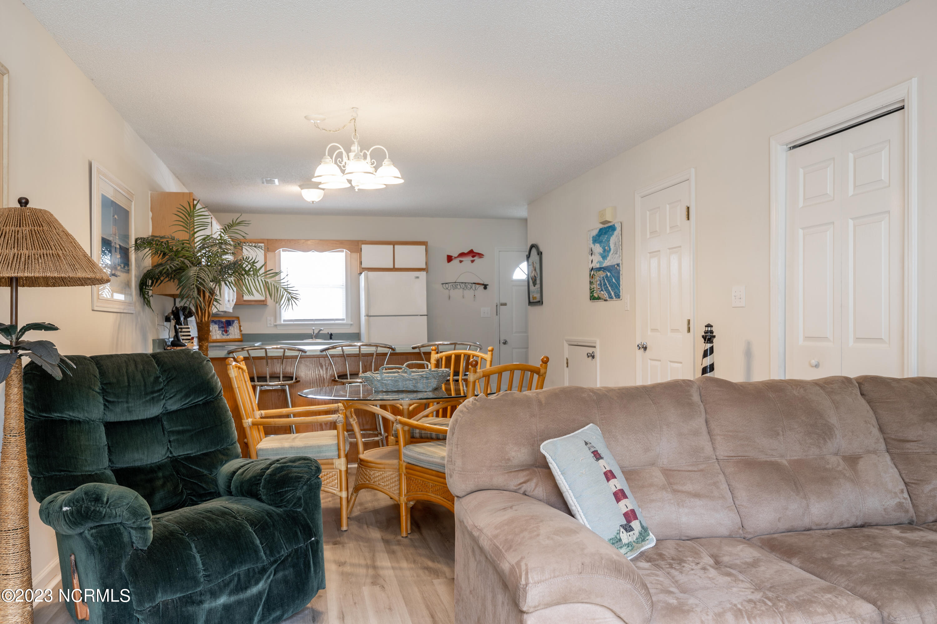 601 Peletier Loop Road, Unit E27 Swansboro, NC 28584 - Photo 9 of 17 View from Living Room (including door to laundry closet and half bath located under the stairs)