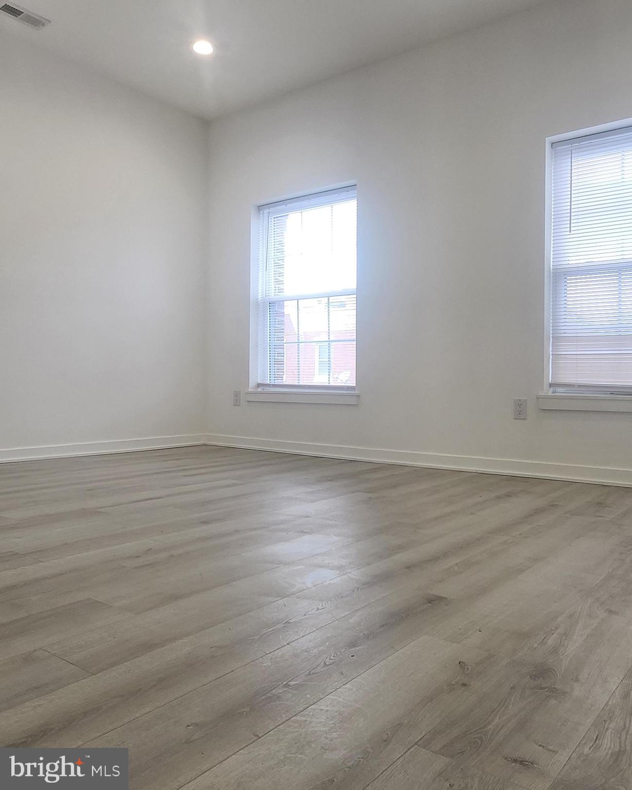 2230 Christian Street, Unit 3 Philadelphia, PA 19146 - Photo 11 of 16 an empty room with wooden floor and windows