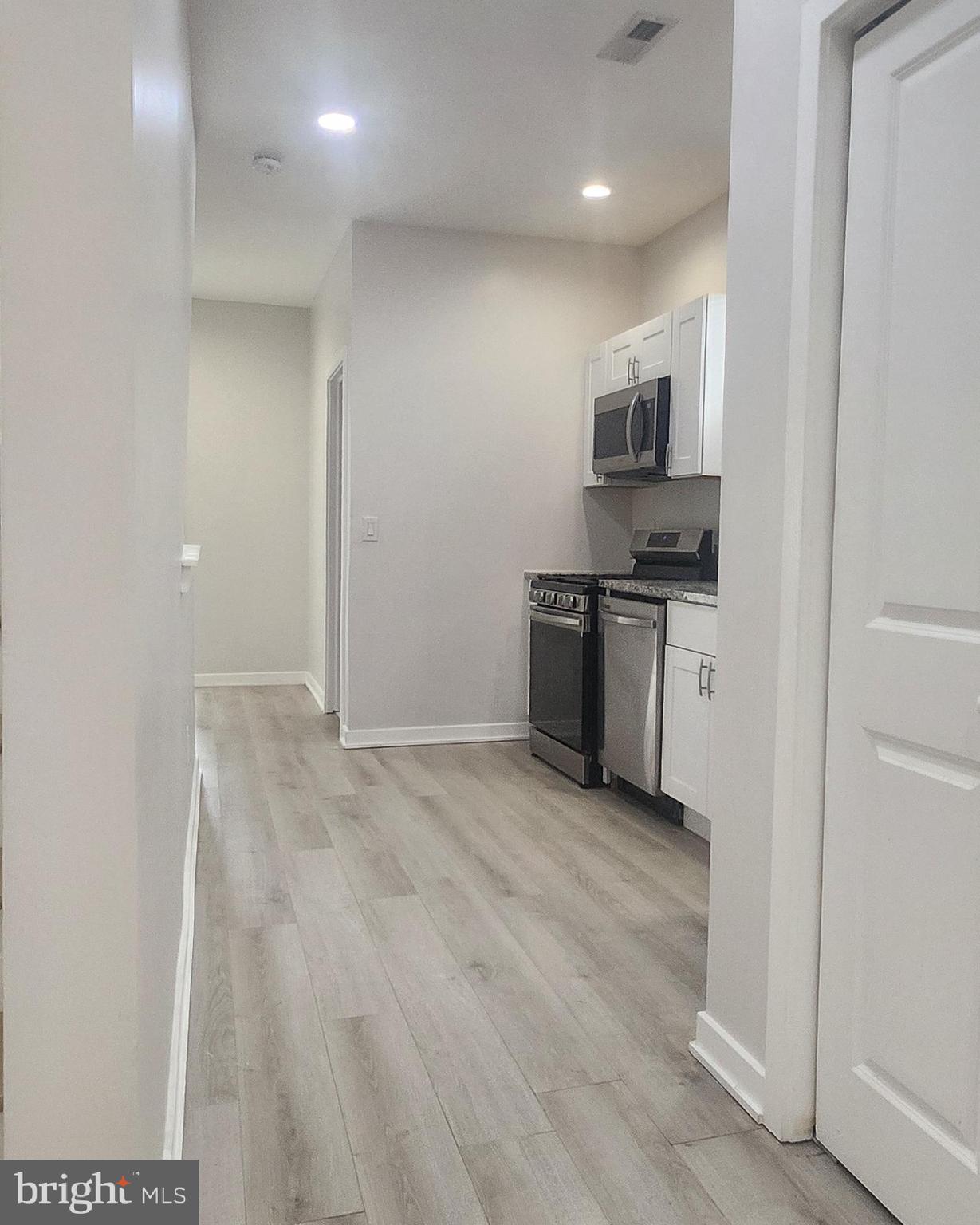 2230 Christian Street, Unit 3 Philadelphia, PA 19146 - Photo 6 of 16 a view of a kitchen with stainless steel appliances granite countertop a refrigerator and a stove top oven