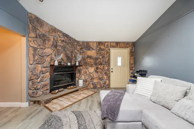 a living room with furniture a flat screen tv and a fireplace