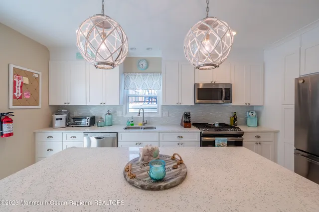 a kitchen with a refrigerator a stove a microwave and cabinets