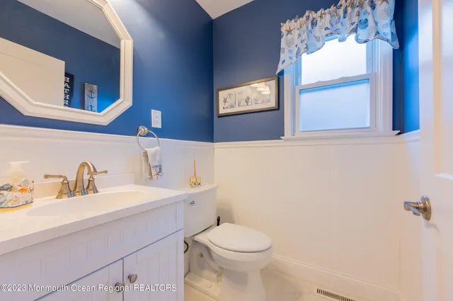 a bathroom with a toilet sink and mirror