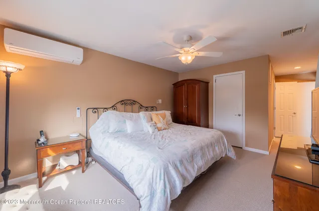 a bathroom with a sink toilet vanity and window
