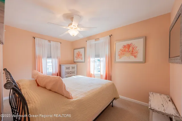 a bathroom with a granite countertop sink a toilet and a mirror
