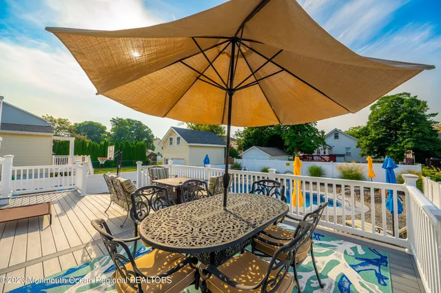 a view of roof deck with a barbeque and furniture