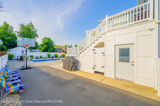 a swimming pool with outdoor seating and yard