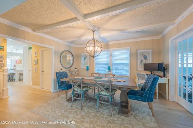 a view of a dining room with furniture and a chandelier