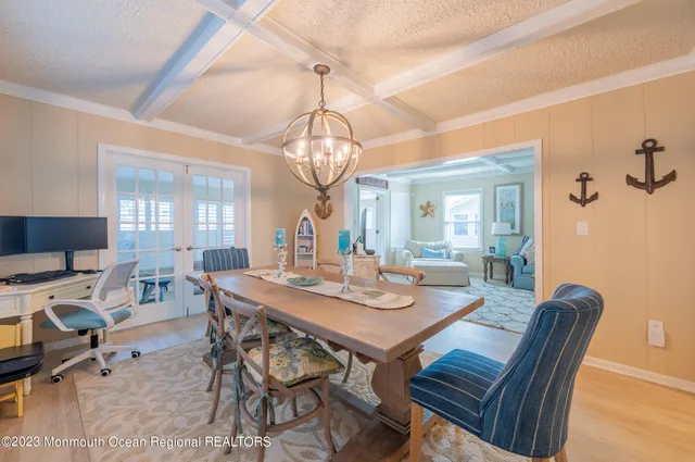 a view of a dining room with furniture and chandelier