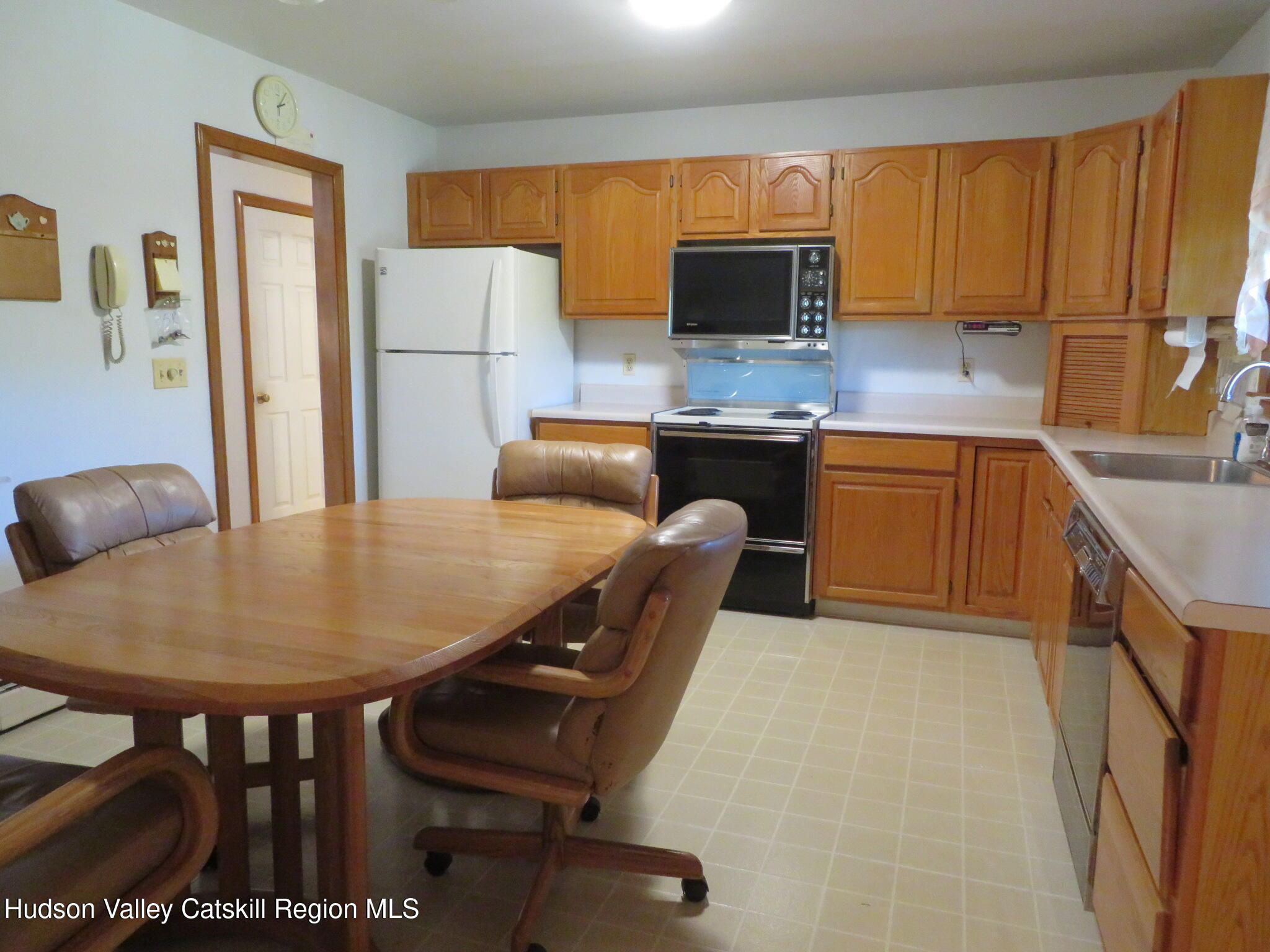 89 Vincent Lane Stone Ridge, NY 12484 - Photo 11 of 45 a kitchen with stainless steel appliances granite countertop a sink a microwave cabinets and a refrigerator