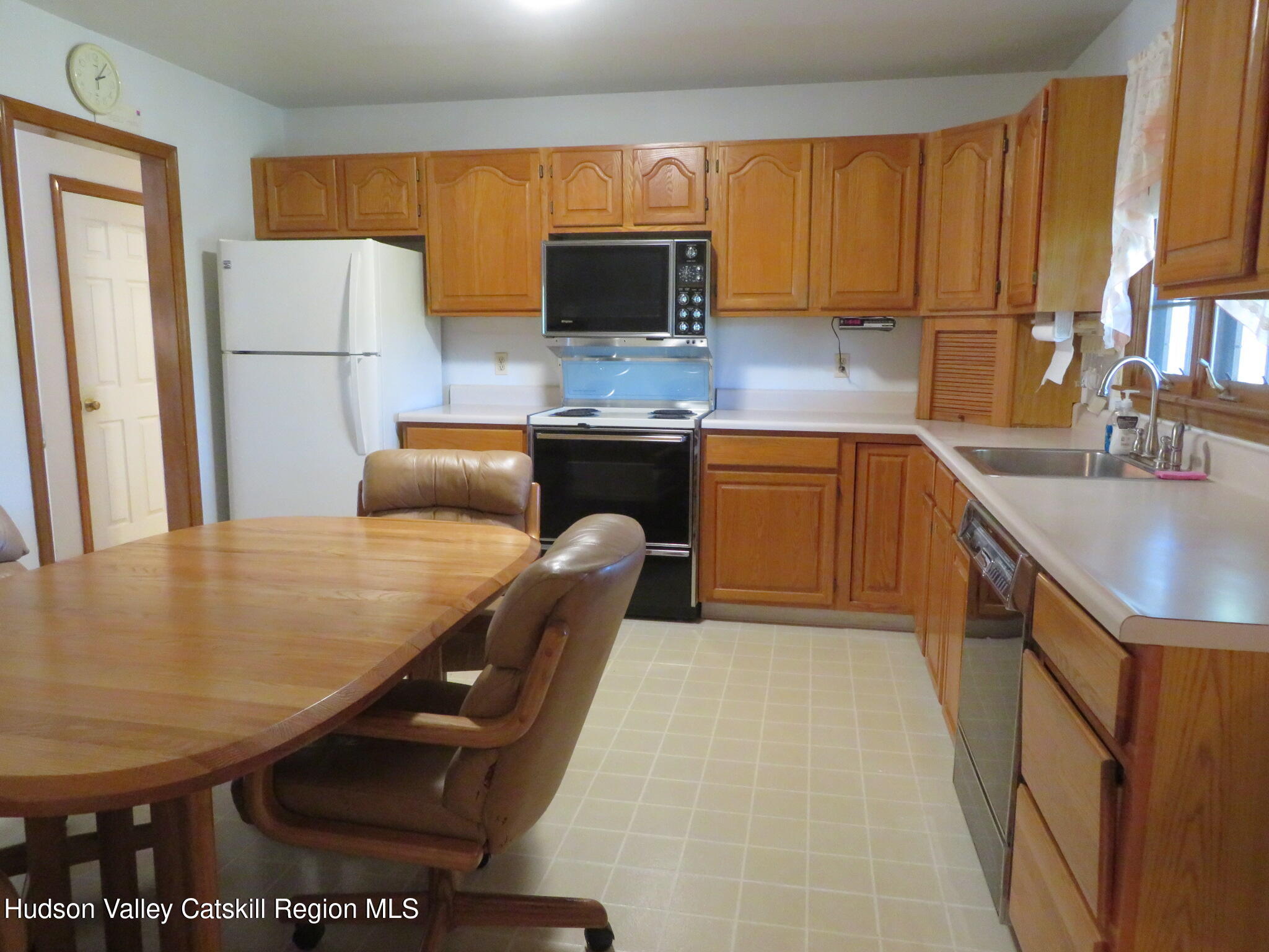 89 Vincent Lane Stone Ridge, NY 12484 - Photo 13 of 45 a kitchen with granite countertop a sink a stove and refrigerator