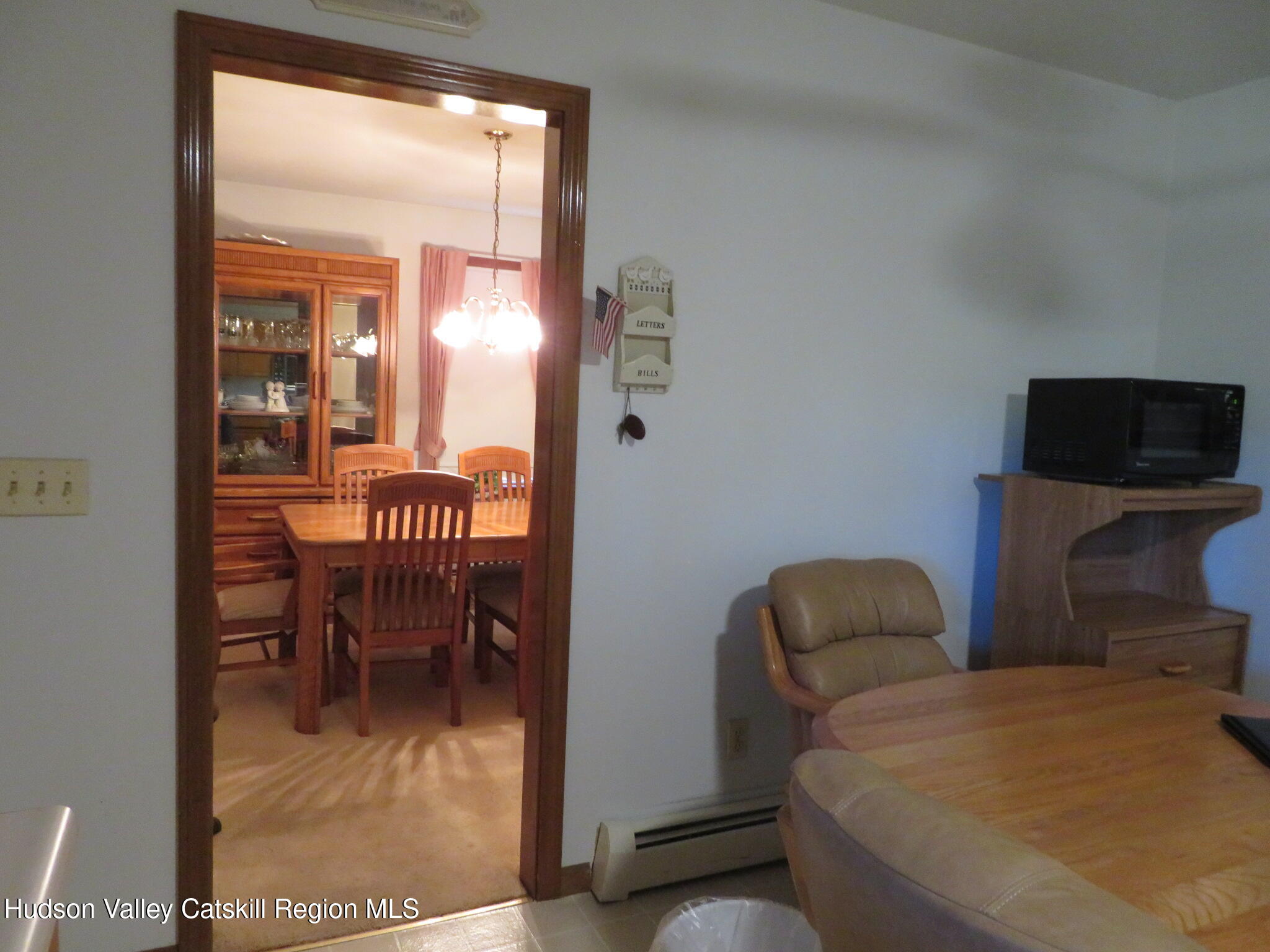 89 Vincent Lane Stone Ridge, NY 12484 - Photo 16 of 45 a dining room with furniture and a floor to ceiling window